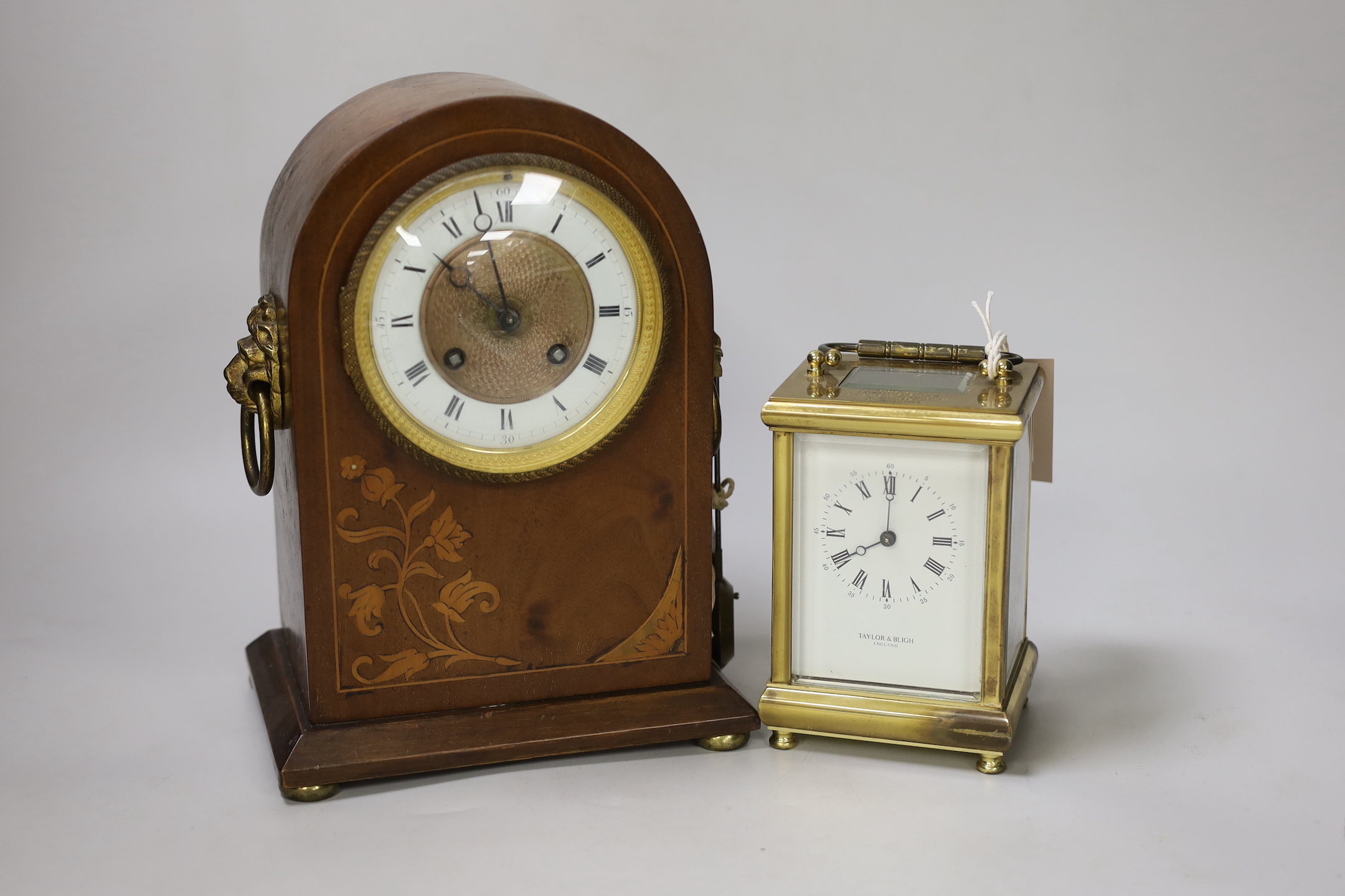 A brass presentation carriage clock together with an inlaid mahogany mantel clock